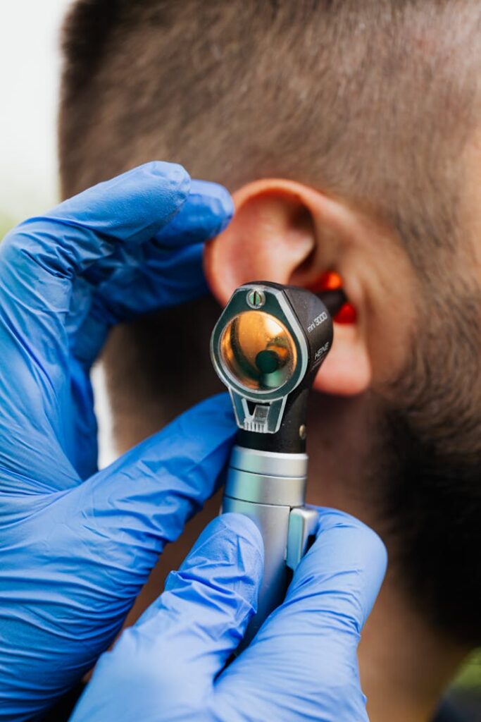 pexels photo 5206945 Close-up of a doctor using an otoscope to examine a patient's ear.